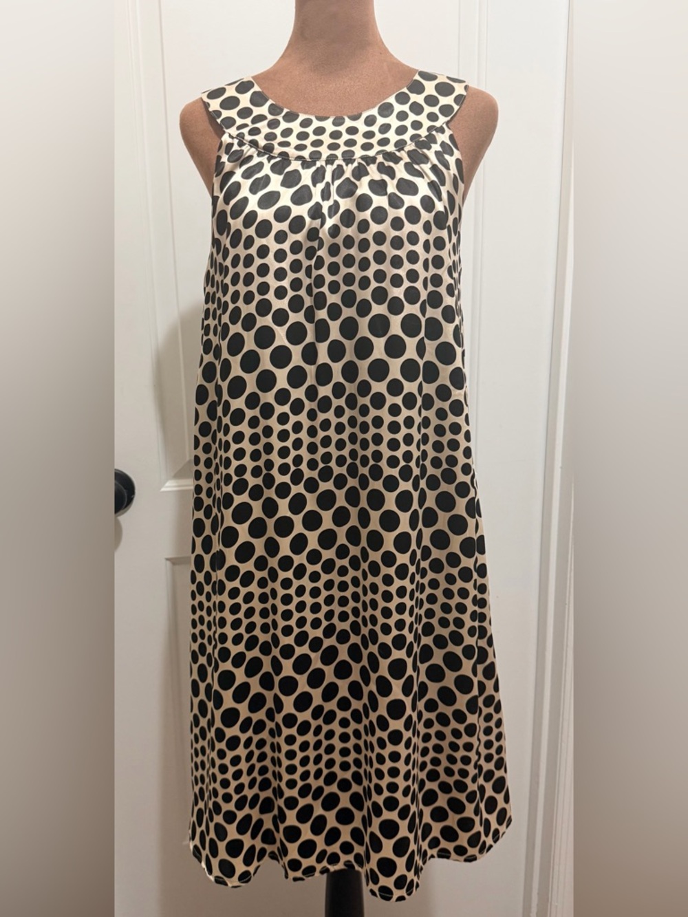 AGB sleeveless Satin Finish Midi Dress with black and gold polka dot pattern.